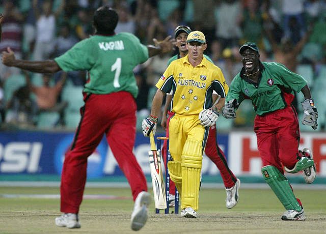 Aasif Karim and wicketkeeper David Obuya celebrate after Hogg is caught and bowled for a duck