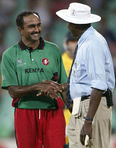 Aasif Karim shakes hands with umpire Steve Bucknor at the end of the match