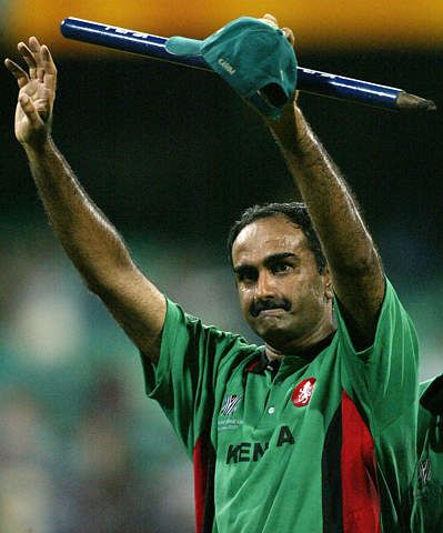 Aasif Karim waves to the crowd as he walks off the field