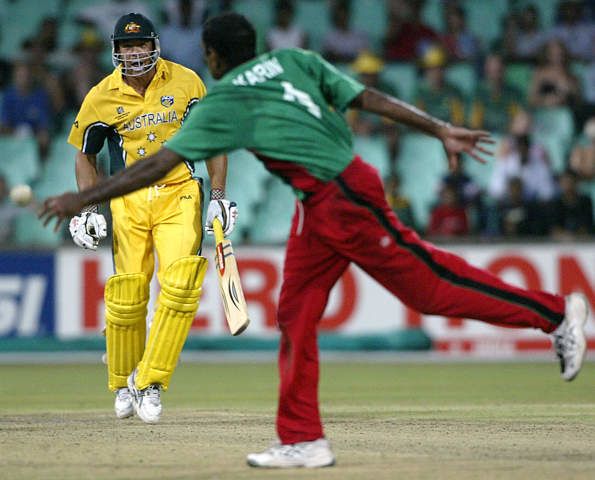 Karim (L) reaches out to stop a ball hit by Symonds