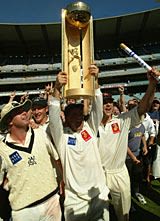 Darren Berry, captain of the Victoria Bushrangers, holds up the Pura Cup after Victoria defeated Queensland in the final