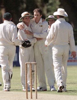 Brian Murphy is greeted by teammates after removing Javed Omar
