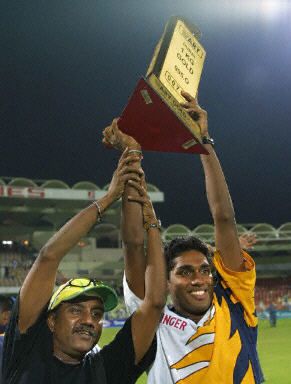 A Sri Lankan supporter raises the ARY Gold Cup with Akalanka Ganegama