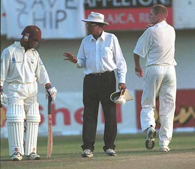 Umpire Venkat finds the need to have a word with Leon Garrick