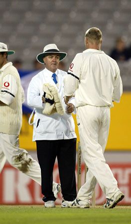 Cowie hands back Flintoff his jersey at the end of an over