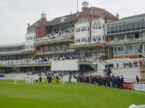 Players and Officials from Surrey and Sussex gather for two minutes silence in front of The AMP Oval Pavilion.