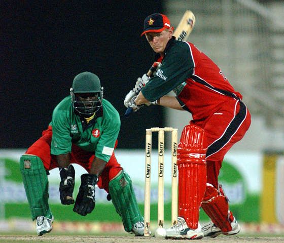 Zimbabwe's Dougas Marillier plays a shot as Kenyan wicket keeper looks on