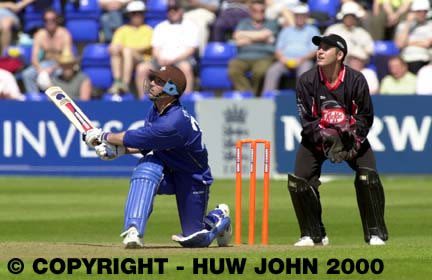 Graham Thorpe hits a boundary watched by Adrian Shaw
