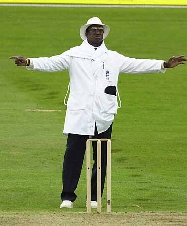 Umpire Vanburn Holder signals a wide