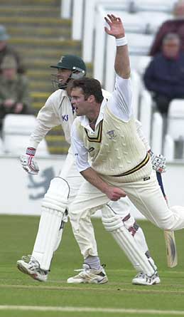 James Brinkley steaming in to bowl past Bicknell of Notts