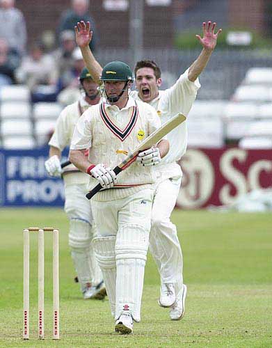 Tom Lungley , arms aloft, has just had Vince Wells caught behind for 7
