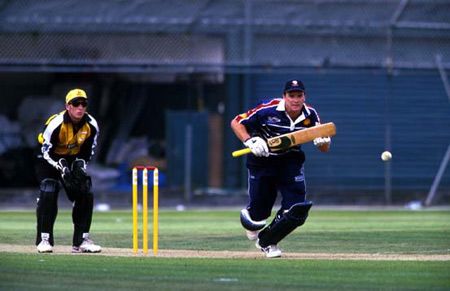 Nash drives down the ground while Nevin looks on. Shell Cup: Auckland v Wellington at Auckland, 27 Dec 2000