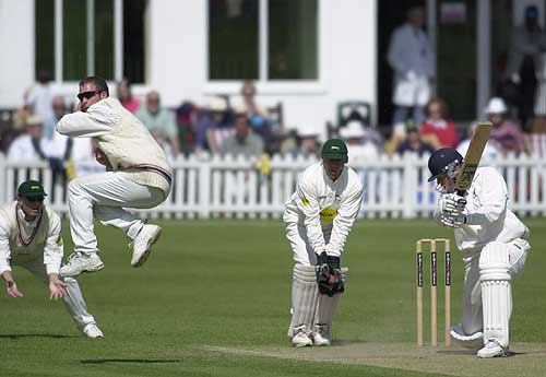 Darren Stevens of Leics has to take avoiding action as Pollock hits out, but the ball is in the gloves of keeper Burns
