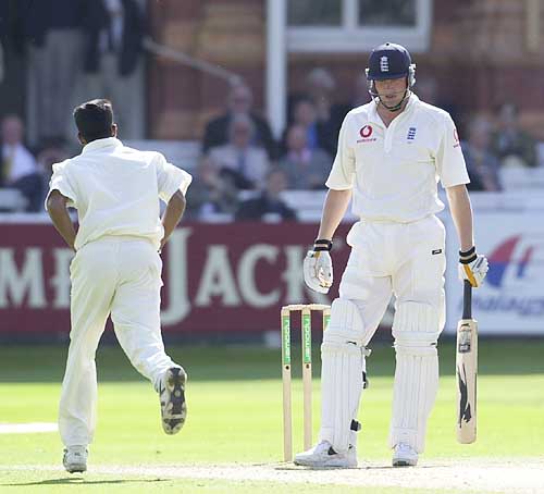 Rueful Freddie Flintoff as victorious bowler Fernando runs past him, Flintoff caught behind for 12