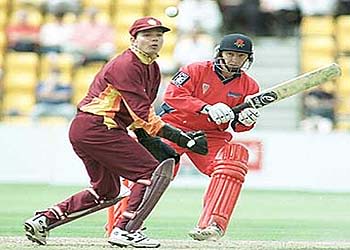 Neil Fairbrother plays the ball fine as Northants keeper Ripley looks on