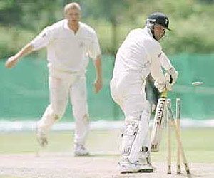 Simon Renshaw looks back to see his stumps shattered by Flintoff