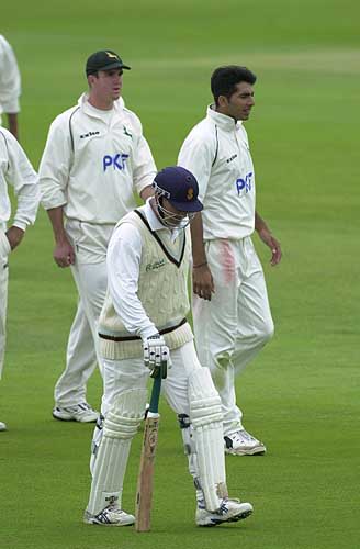 Off trudges Karl Krikken, a victim of Nadeem Malik - in the background.