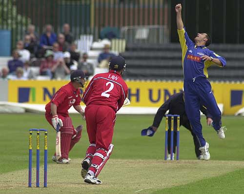 Bowler Jason Kerr tips the ball up from Stuart Law and catches it for a caught and bowled