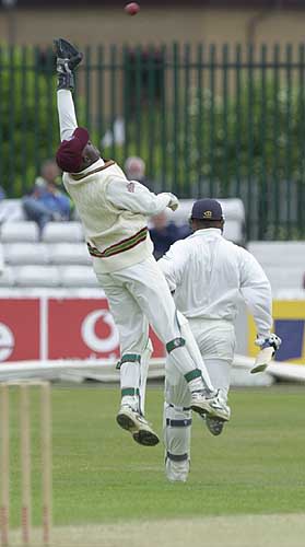 Keith Hibbert has to stretch high for this return