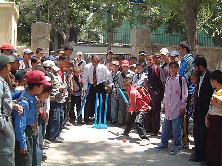 Durrani High School children receiving tips from Taj Malik using Kwik cricket set donated by ECB