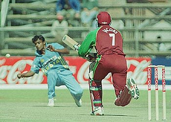 Ridley Jacobs drives Harvinder back past the bowler