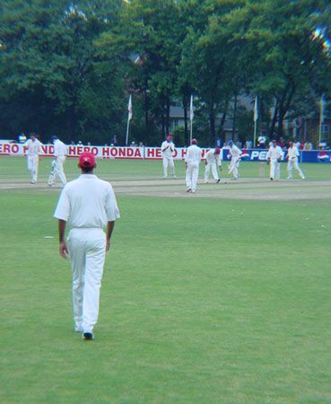 Seebaran walks in from the outfield as the ball is bowled