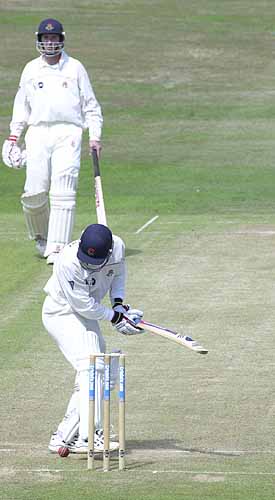 Joe Scuderi has lost this ball from Gough under his feet and is kicking it away from the stumps