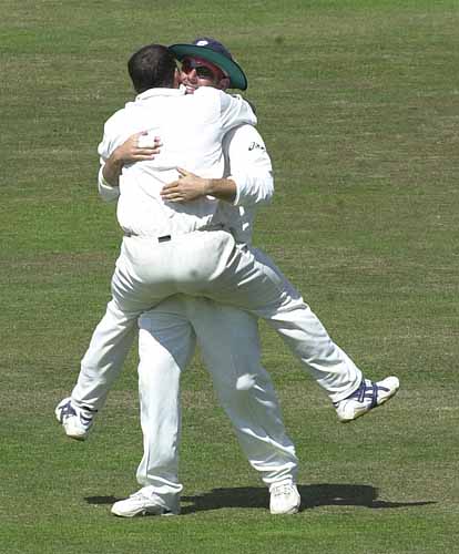 Lehmann and Gough embrace after Gough has got Scuderi out