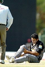 Asim Saeed grimaces after twisting his left knee