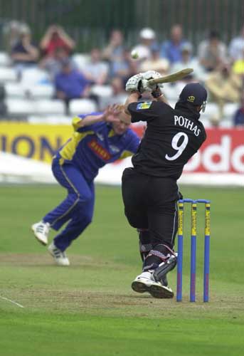 Welch protects himself as Pothas returns the delivery.