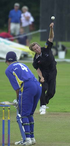 Mullally bowling from the score board end.