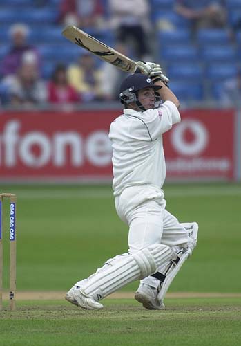 Wood stands firm at the wicket, slamming the ball to the boundary for 4 runs.
