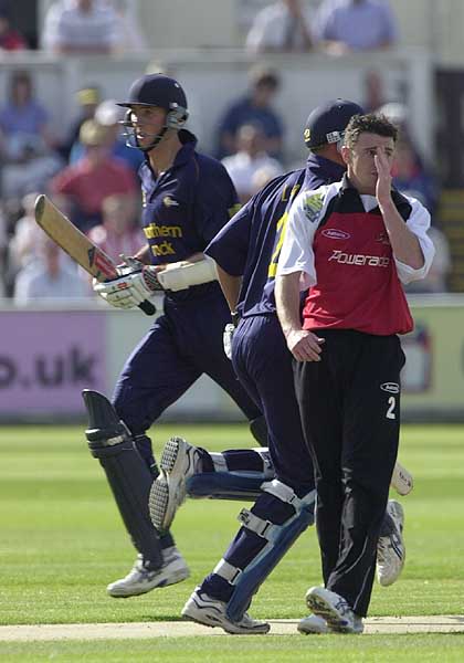 Durham's Michael Gough and Danny Law run past bowler Andrew Davies