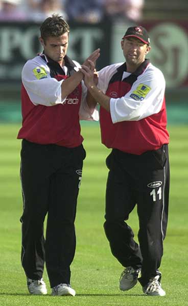 Ian Thomas and Adran Dale celebrate a team effort as Law is dismissed for 15 runs