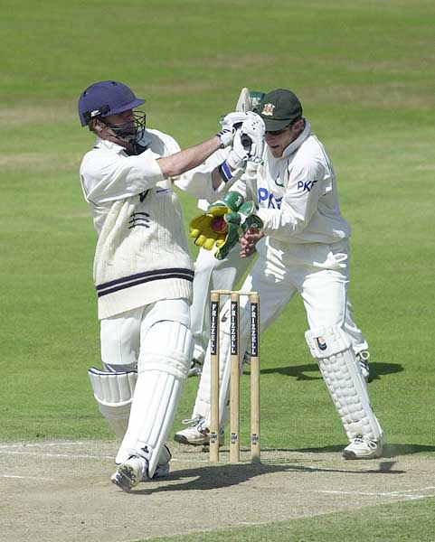 Phil Tufnell with a swing and a miss as the ball finds its way to the gloves of keeper Read