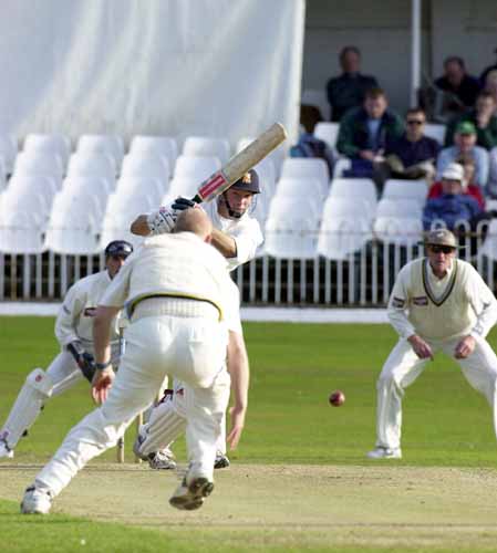 Richard Clinton drives a ball back only for bowler Hoggard to get down to field it