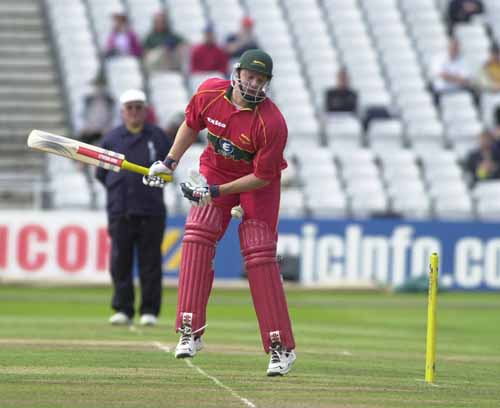 Dakin takes a hit from the delivery of Outlaw bowler Greg Smith