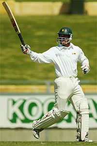 Craig Wishart of Zimbabwe reaches his century