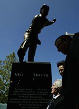 Keith Miller admires his statue during a ceremony at the MCG