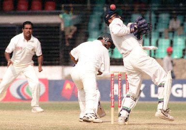 A turning delivery from Sunil Joshi eludes both the batsman, Naimur and Saba Karim