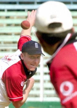 Martyn Ball sends down a delivery to James Foster