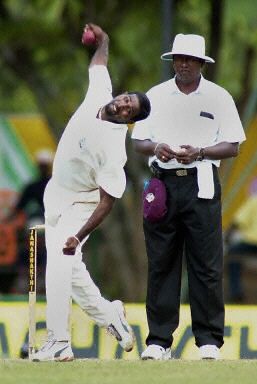 West Indies leg spinner Dinnath Ramnarine bowls as umpire Gamini Silva looks on