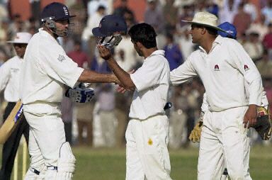 Richard Johnson gets congratulated by Gambhir (l) and Khoda as England win