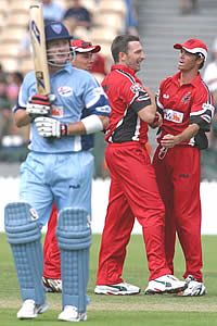 Fleming is congratulated by Blewett & Lehmann after bowling Clarke, South Australia v New South Wales, ING Cup, 2002/03