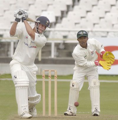 Andrew Puttick drives a ball against North West