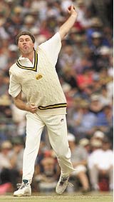 Bruce Reid of the Chairman's XI sends down a delivery