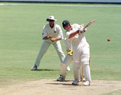 Brian McMillan pulls a ball