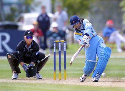 Anju Jain swings to hit the ball