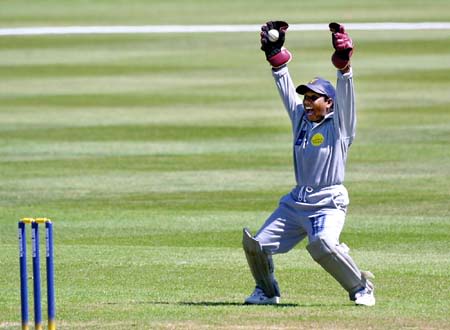 Sri Lankan wicket keeper Thanuja Ekanayake holds the ball she caught behind from England captain Clare Connor