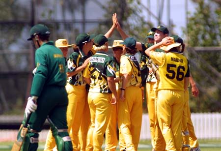 Australian team gather to celebrate the wicket of opening batter Linda Olivier, caught by Cathryn Fitzpatrick for 41